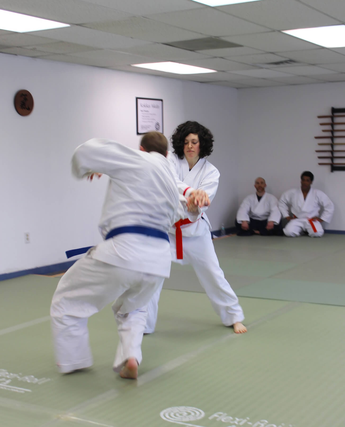 Female throwing blue belt